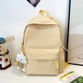 Detail of yellow checkered backpack featuring side drawstring pockets and cloud plush charm - Yellow