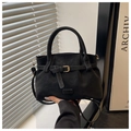 Detail view of black faux suede tote with metallic eyelet strap and cylindrical handles - Black
