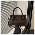 Detailed view of matte dark coffee suede tote with golden buckle and leather strap texture - Coffee