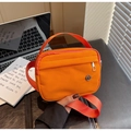 Bright orange waterproof nylon crossbody bag with front zipper and round metal logo charm - Orange
