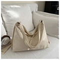 Detail of soft cream PU leather tote bag with subtle texture and gold-tone hardware - Off White