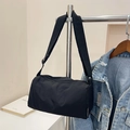 Black nylon cylinder crossbody bag with wide adjustable strap and casual minimal design - Black