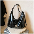Detail of glossy black faux leather tote with rectangular metal logo plate - Black