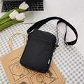 Compact black corduroy crossbody phone bag with adjustable strap and sport tag detail - Black