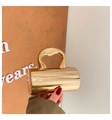 Elegant gold cylindrical evening clutch bag with high-gloss finish and curvy handle - Light gold