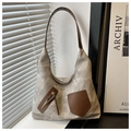 Close-up of grey washed canvas tote bag with brown leather pocket and zipper details - Gray
