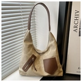 Detail of vintage canvas tote bag with brown leather trim and asymmetric zip pocket design - Khaki