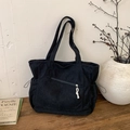 Minimalist black corduroy tote bag with side drawstrings and front zipper pocket detail - Black