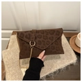 Detail of leopard print envelope bag with gold chain strap in a cozy social setting - Coffee