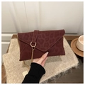 Close-up of wine red envelope bag with leopard pattern and gold chain strap detailing - Red