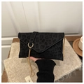 Close-up of leopard print envelope bag featuring a gold chain and metal ring buckle - Black
