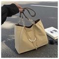 Detail of beige tote bag featuring pearl gold chain strap and elegant floral pendant charms - Khaki