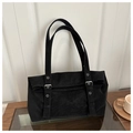 Detail of black faux suede tote bag featuring silver buckles and stylish metal eyelets - Black