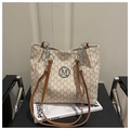 Detail view of canvas tote bag featuring brown M-letter prints and silver metal logo - White