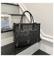 Close-up of leopard print canvas tote with black leather trim and functional front pockets - Leopard Print Black