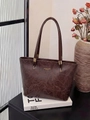 Detailed macro view of deep brown faux leather tote bag with elegant gold foil branding - Brown
