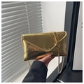 Detailed macro view of the gold envelope bag featuring vertical pleated metallic texture - Gold