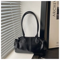 Detail of black glossy vintage wax leather tote bag with side pleats and slim straps - Black