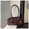 Detail view of deep brown vintage oil-wax leather tote bag with glossy finish and side buckle - Coffee