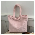 Detailed macro view of the soft pink plush lamb wool fabric on a large tote bag - Pink