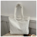 Close-up of white plush fleece tote bag texture on wooden table with cozy items - White