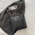 Minimalist black tote bag in premium faux leather texture with twin handles - Black