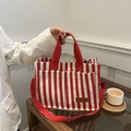 Red and white vertical striped canvas tote bag with dual front pockets and shoulder strap - Red