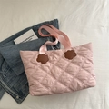 Pink quilted tote bag with floral accents and spacious interior for daily commute - Pink