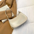 Minimalist cream patent leather baguette shoulder bag with gold hardware and slim strap - White