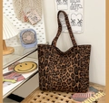 Dettaglio della borsa tote in tela con stampa leopardata su una panca in legno in ufficio - Stile Standard (Leopardo)