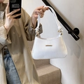 White crescent underarm bag with V-woven texture and gold hardware details - White