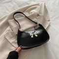 Elegante borsa sottobraccio nera con fiocco dorato e finitura plissettata - Nero