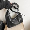 Black crescent hobo bag with geometric patchwork and ruffled cloud handle detail - Black