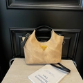 Fashionable camel bucket bag with black handles, adjustable strap and iconic yellow badge - Black Without Charm