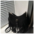 Close-up of black bohemian tassel shoulder bag with metallic buckle and fringe details - Black