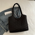 Black heart quilted puffy tote bag shown with casual denim jacket on white background - Black