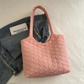 Pink heart quilted puffy tote bag displayed with denim jacket and lifestyle books - Pink