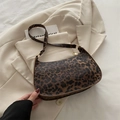Chic leopard print shoulder bag with golden hardware and zipper on a beige jacket - Leopard Print Style / Brown