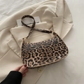 Fashionable leopard print hobo shoulder bag with gold zipper on a beige blazer - Leopard Print Style / Brown