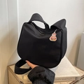 Detail of black canvas dumpling bag with cat ear shape and hamburger charm accessory - Black