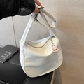 Minimalist white crescent shoulder bag with burger charm on a wide adjustable strap - White