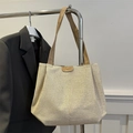 Minimalist beige woven tote bag with brown leather straps and branded circular patch - Khaki