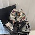 Floral jacquard and black leather drawstring bucket bag with gold zipper and strap - Black