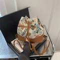 Vintage floral canvas bucket bag with brown leather drawstrings and gold hardware detail - Brown
