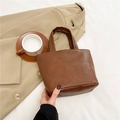 Retro brown wrinkled leather tote bag for women shown with professional office wear - Brown
