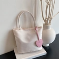 Minimalist cream nylon mini tote bag with a pink leather heart charm and slim handles - White