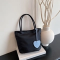 Black nylon mini tote bag featuring a light blue heart charm on minimalist double handles - Black