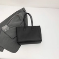 Minimalist black faux leather tote bag with slim straps for professional office commute - Black