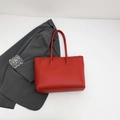 Chic red faux leather tote bag with long handles for shoulder wear or hand carrying - Red