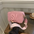 Pink camera bag with SM logo and geometric wide strap shown from a side angle - Pink